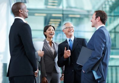 Portrait of cheerful business people laughing over conversation
